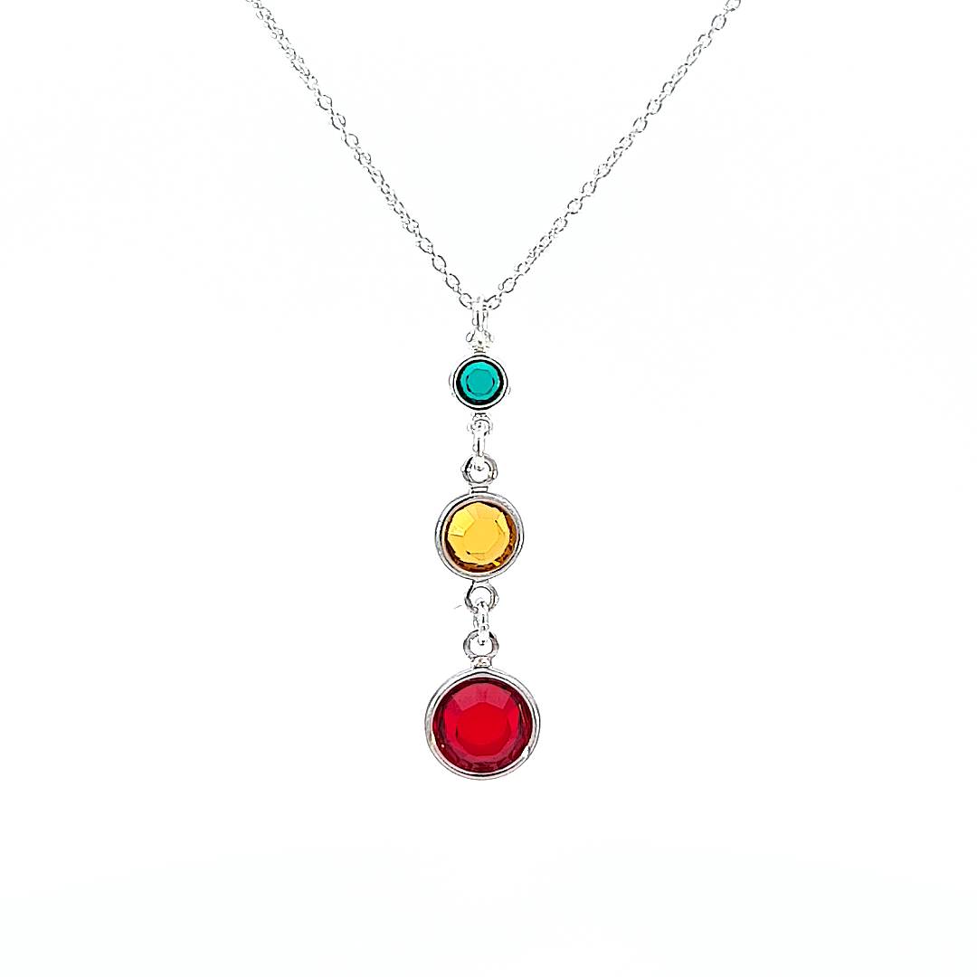Sterling Silver necklace with tiered birthstones representing three generations, featuring birthstone crystals in varying sizes, set against a  white backdrop.
