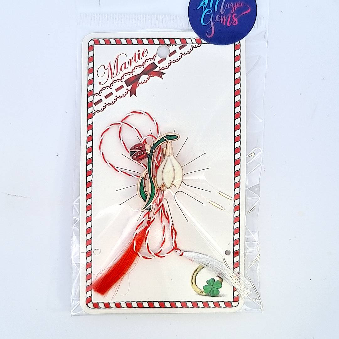 The 'Whispers of Spring' Martisor brooch with traditional Martisor string, ready to celebrate the spring season with a story card in a clear bag.