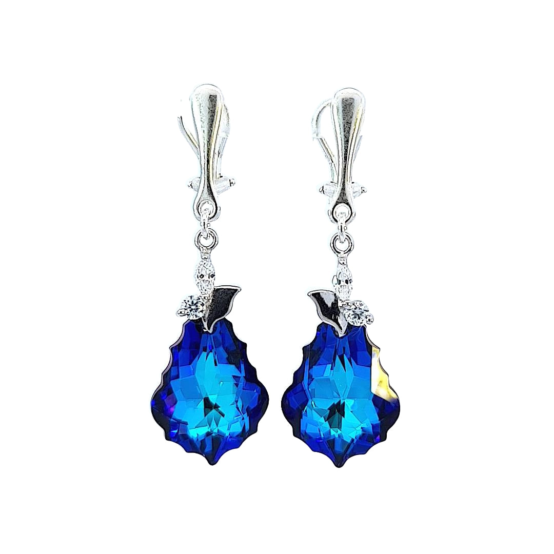 Sterling silver statement drop earrings with deep blue faceted crystal teardrops and delicate detailing, handcrafted by Magpie Gems in Ireland.