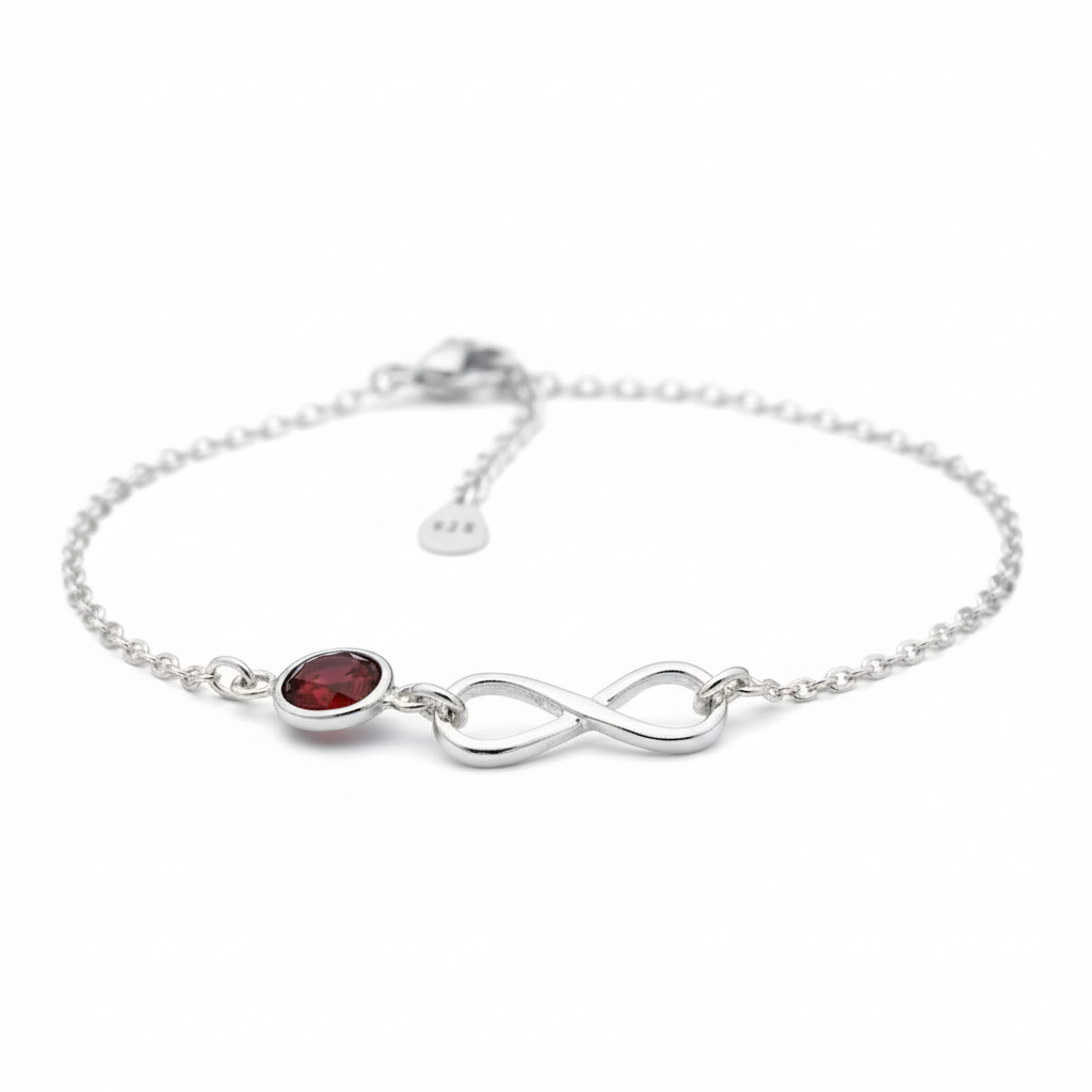 Sterling silver bracelet for women with a red January birthstone gemstone and infinity symbol on a white background