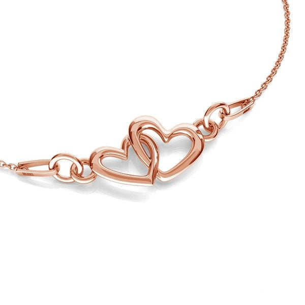 Close-up of rose gold Two Hearts as One necklace showing delicate interlocking heart pendant, by Magpie Gems in Ireland. 