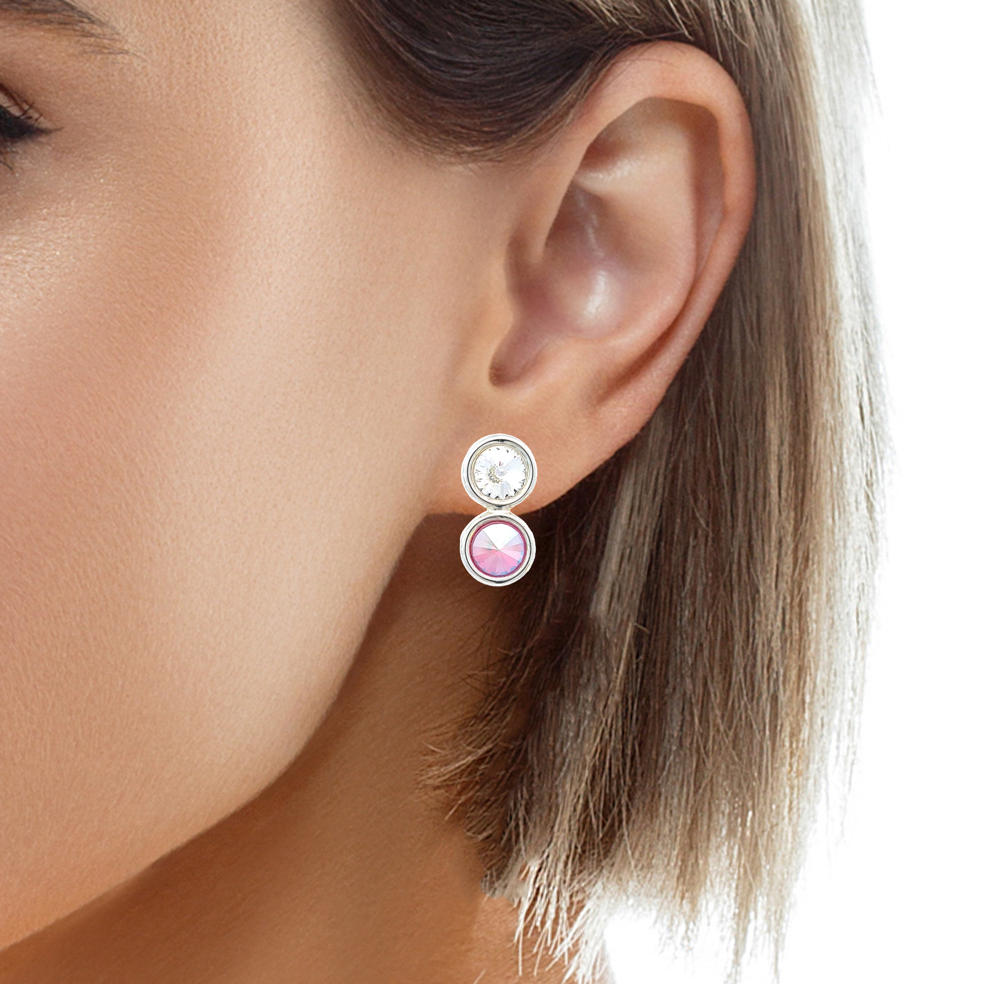 Woman wearing a pair of nickel-free sterling silver clip-on earrings by Magpie Gems, showcasing a front view of rivoli crystals reflecting a spectrum of colours.