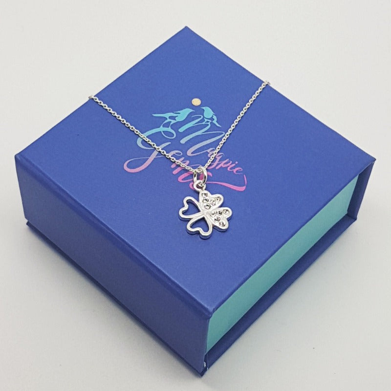 Gift box of Lucky Sparkle Sterling Silver Necklace with Clover Pendant and Austrian Crystals on a gift box from Magpie Gems Ireland