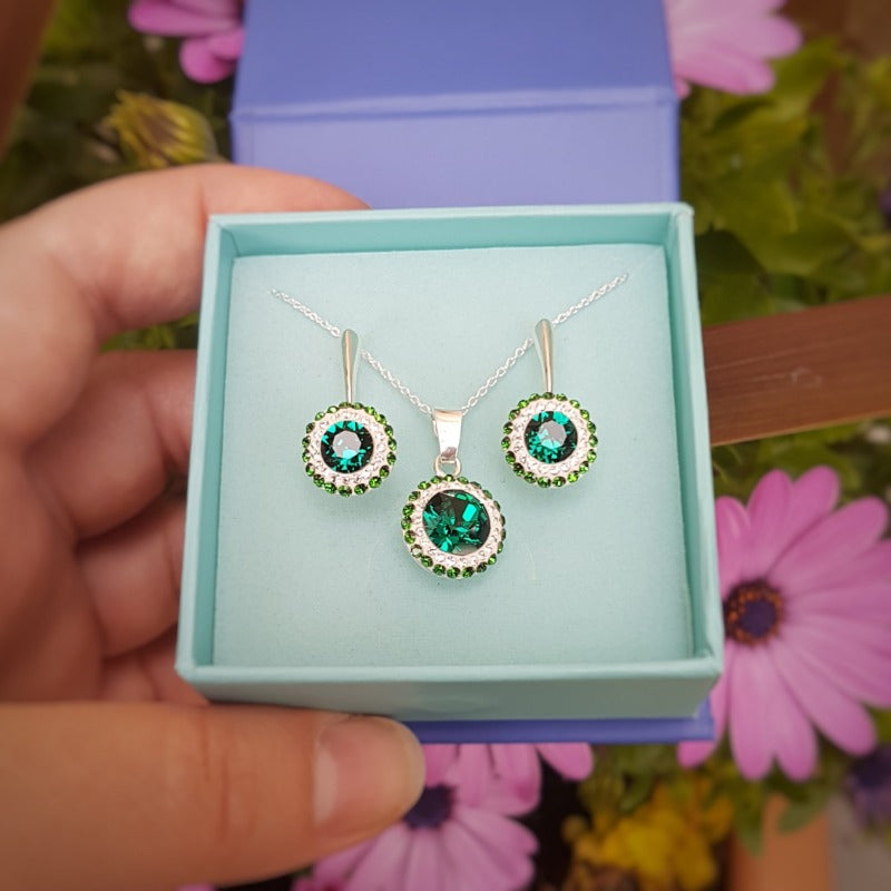 An emerald and clear halo silver jewellery set, leverback drop silver earrings and round silver pendant necklace in Ireland