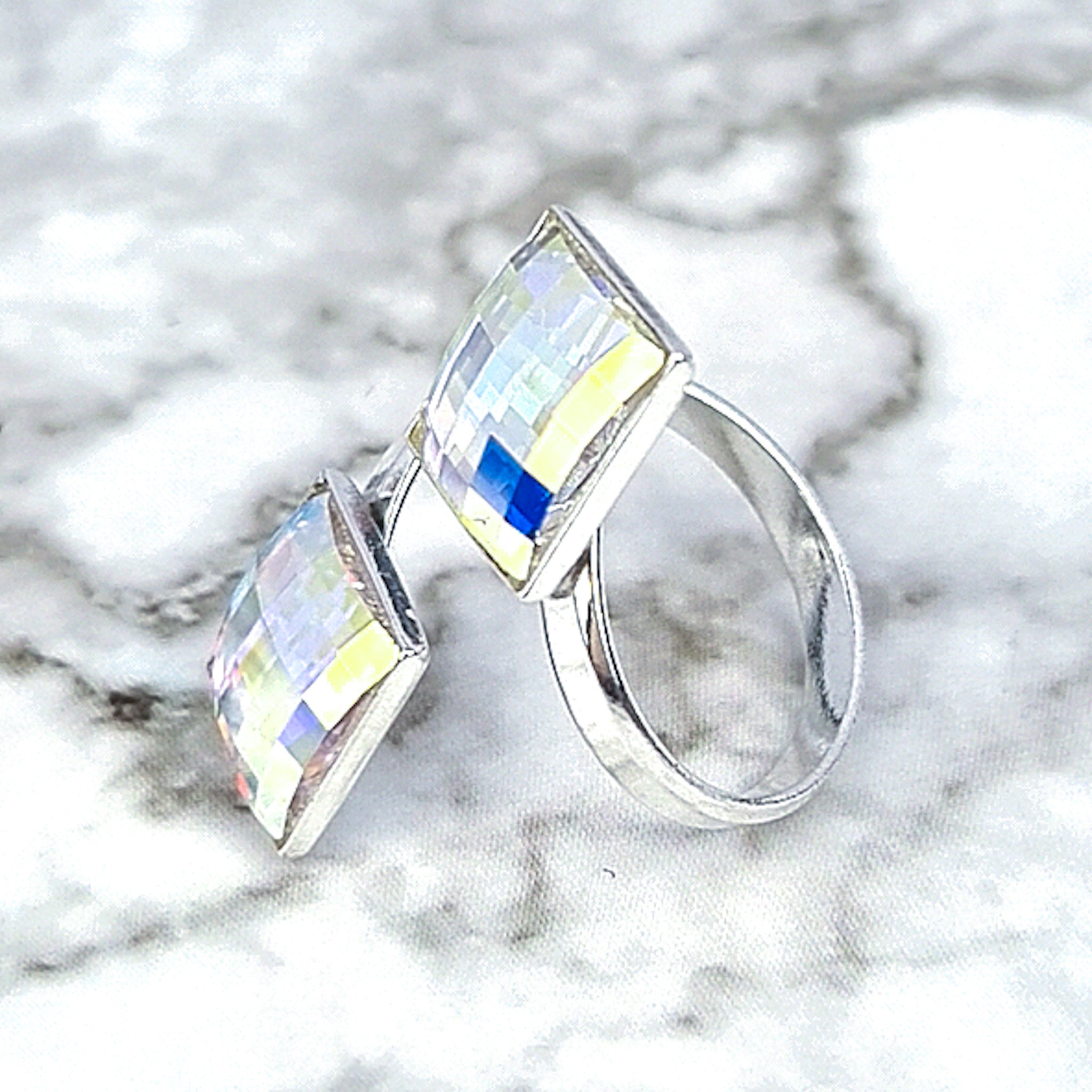 Close-up image of the Glittering Chessboard Wrap Ring, showcasing the wrap-around design and two square crystals in aurora borealis finish.

Side view of the ring