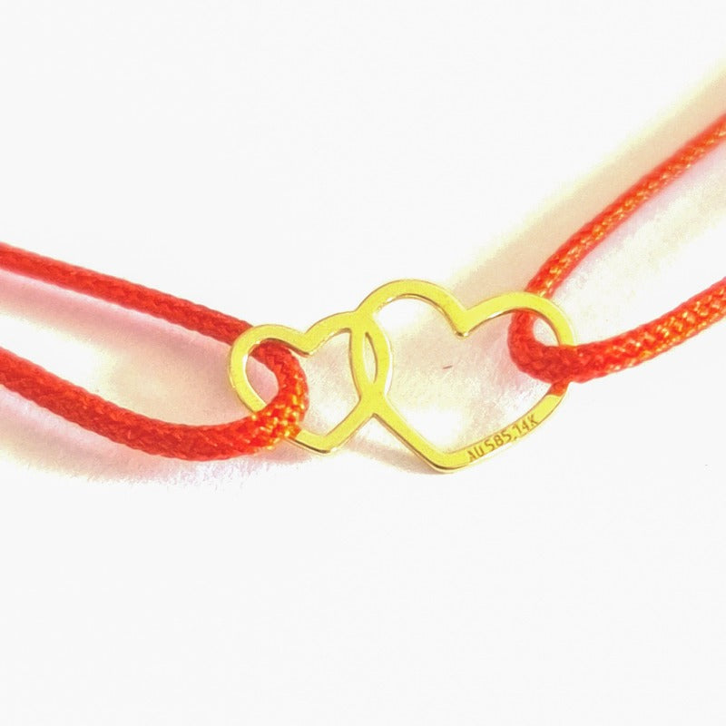 Close up of Double Hearts of Love in 14k Solid Gold Double Heart Slip Knot adjustable bracelet with red cord, shop in Ireland, gift boxed gold jewellery