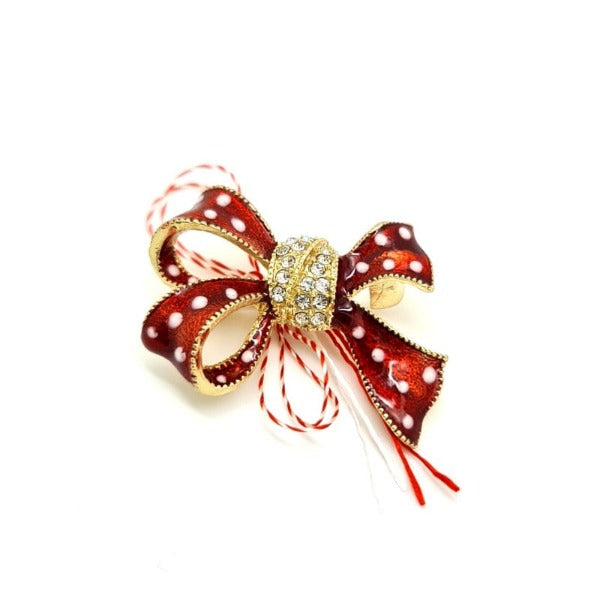 Red and gold bow brooch with crystals encrusted on the middle with a red and white string. A Martisor brooch symbol of spring, love and friendship. Shop in Ireland