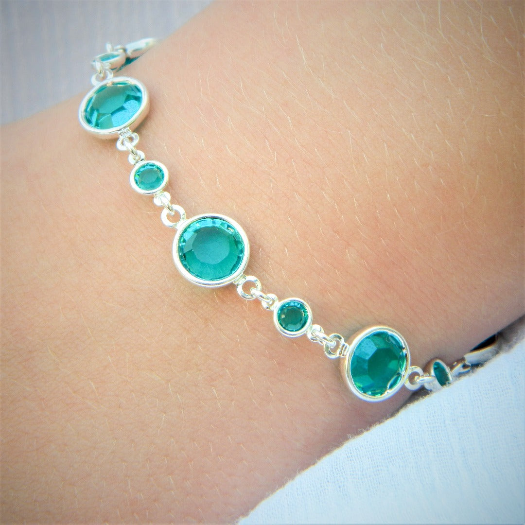 December birthstone sterling silver link bracelet, inlaid with light turquoise crystals, evoking protection and healing, crafted by Irish artisans.