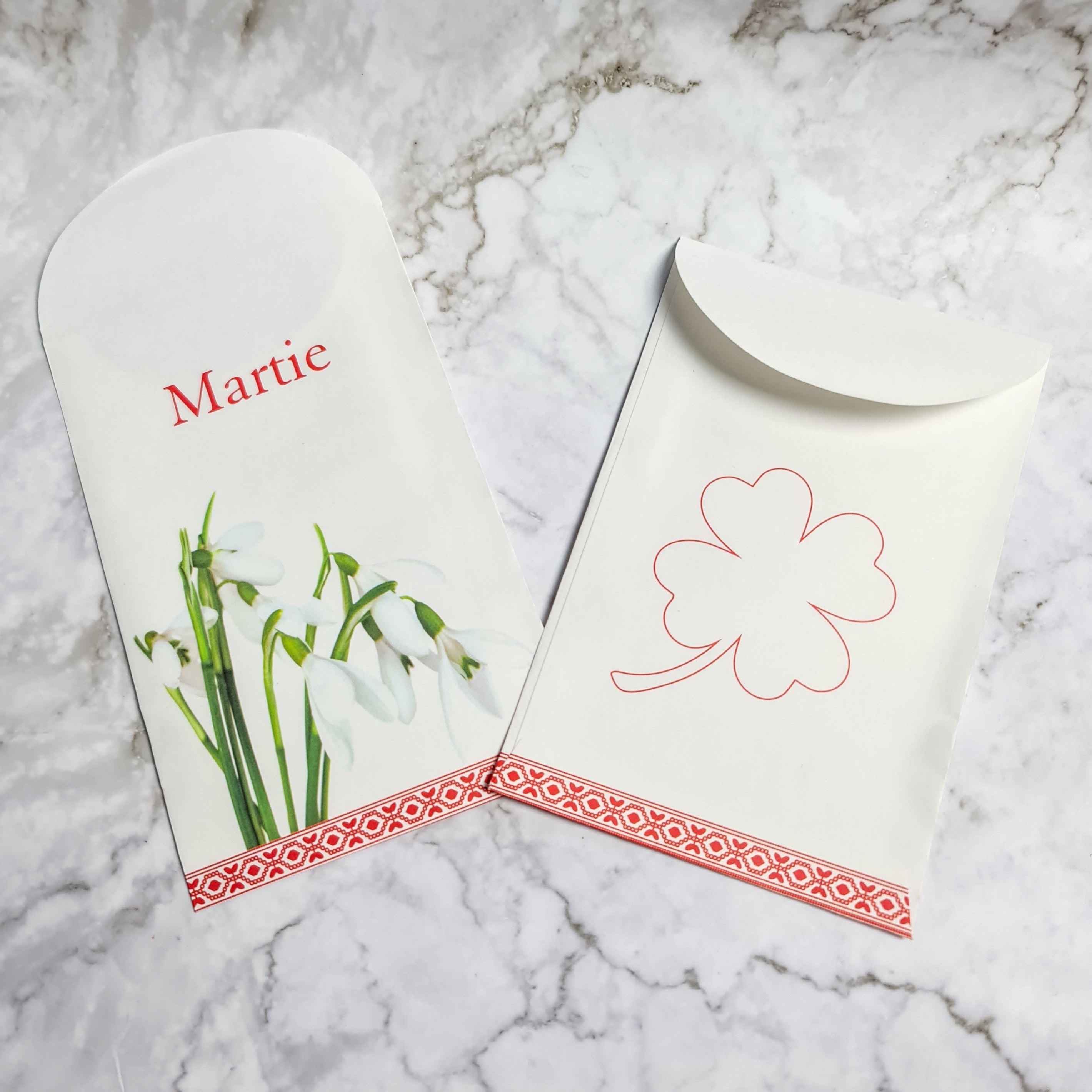 Paper envelope with snowdrops and clover, perfect for Martisor gift-giving.