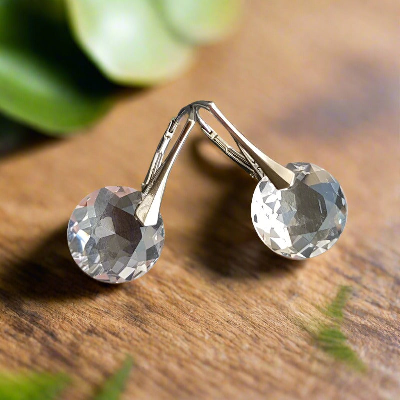 Sterling silver April birthstone drop earrings featuring clear Austrian crystals in a modern hook setting, artisan-made in Ireland by Magpie Gems.