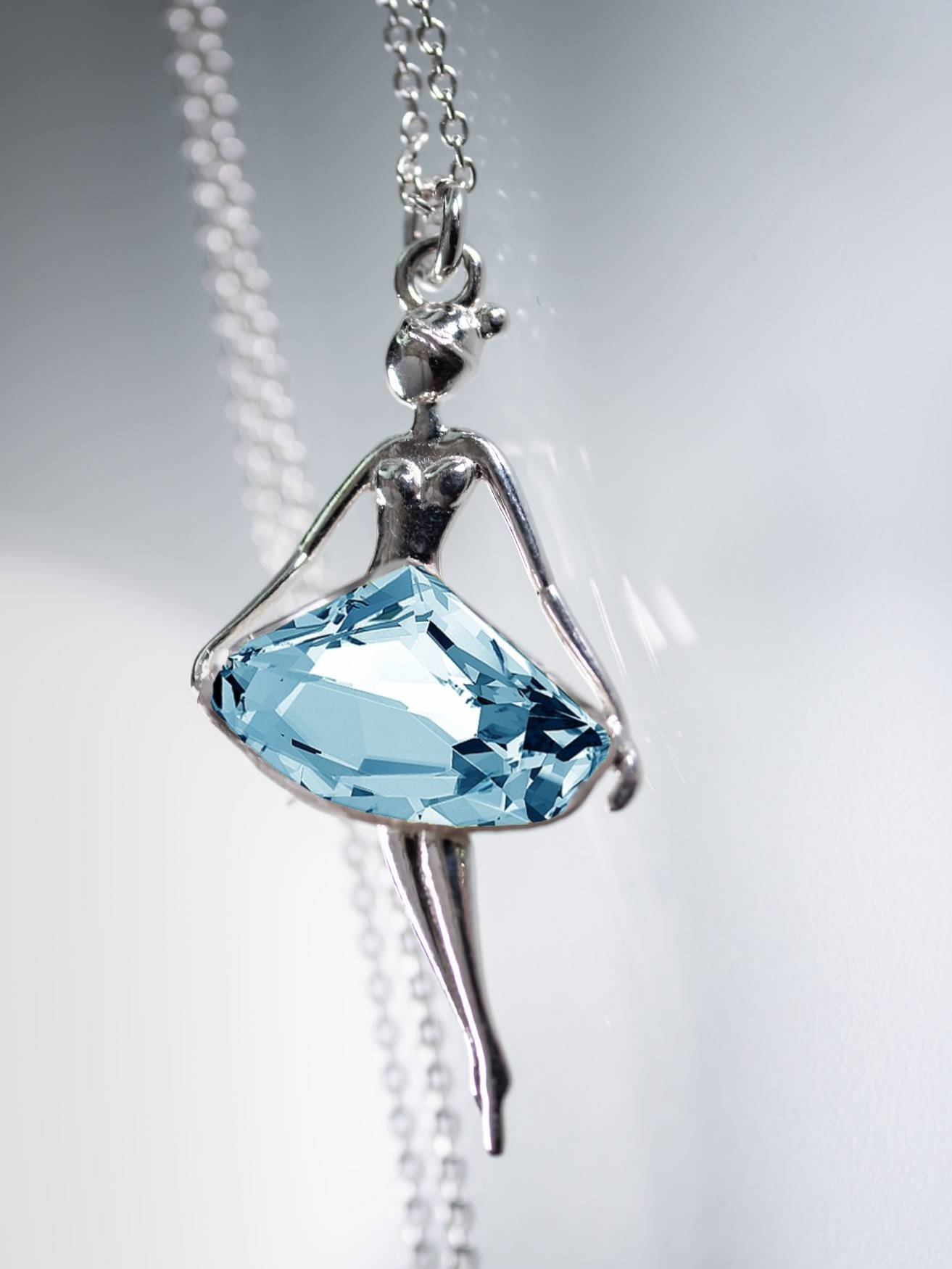 Elegant sterling silver ballerina necklace with a striking aquamarine crystal skirt by Magpie Gems in Ireland.