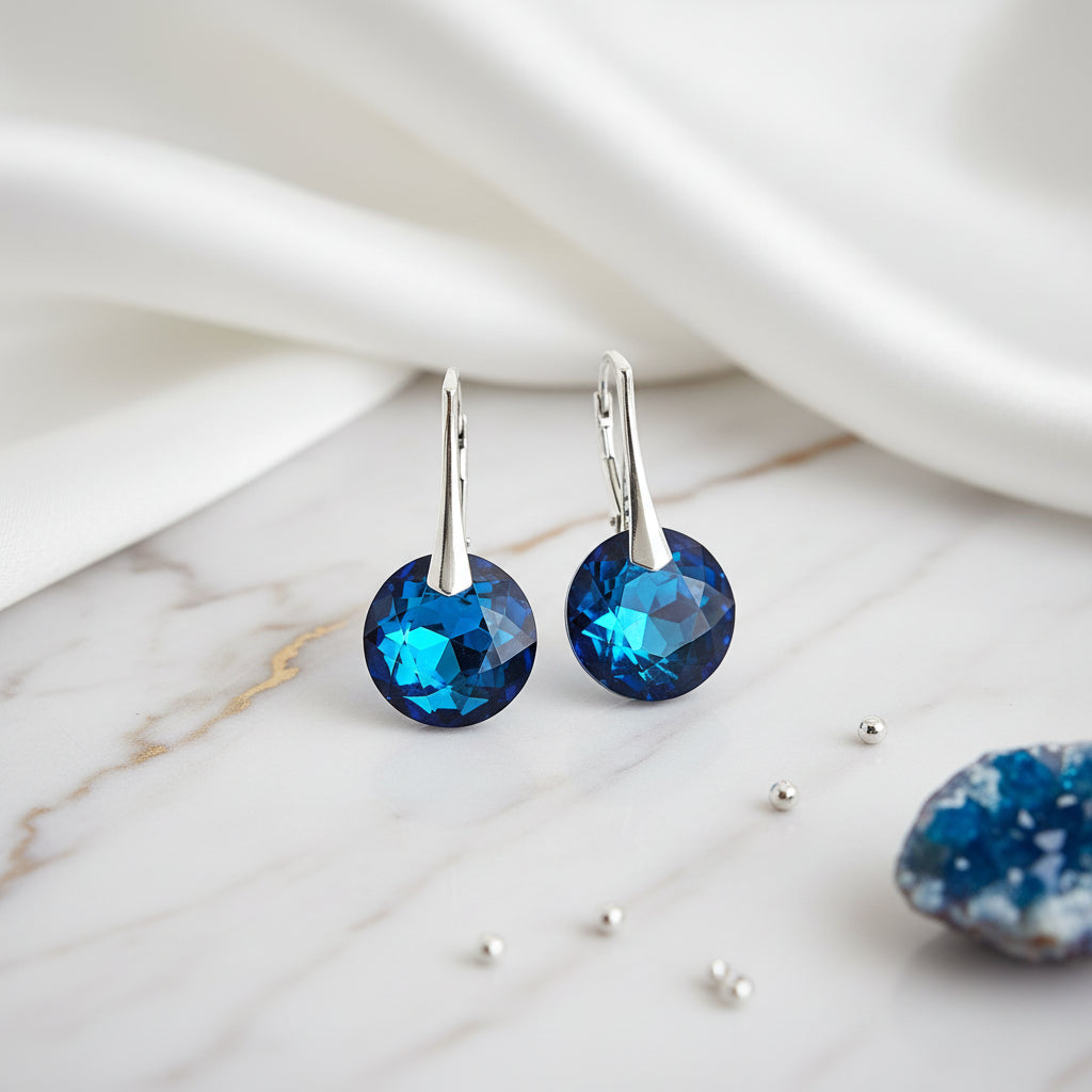 A pair of stylish Bermuda Blue Chaton Crystal Earrings with Sterling Silver 925 leverbacks, handmade for women in Ireland by Magpie Gems Jewellery.