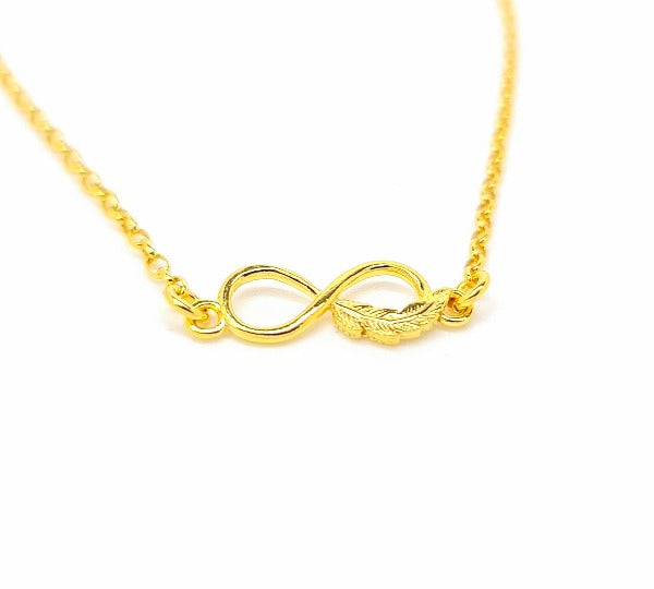A gold infinity with feather pendant necklace, handmade in Ireland with 24k gold plating over 925 sterling silver.
