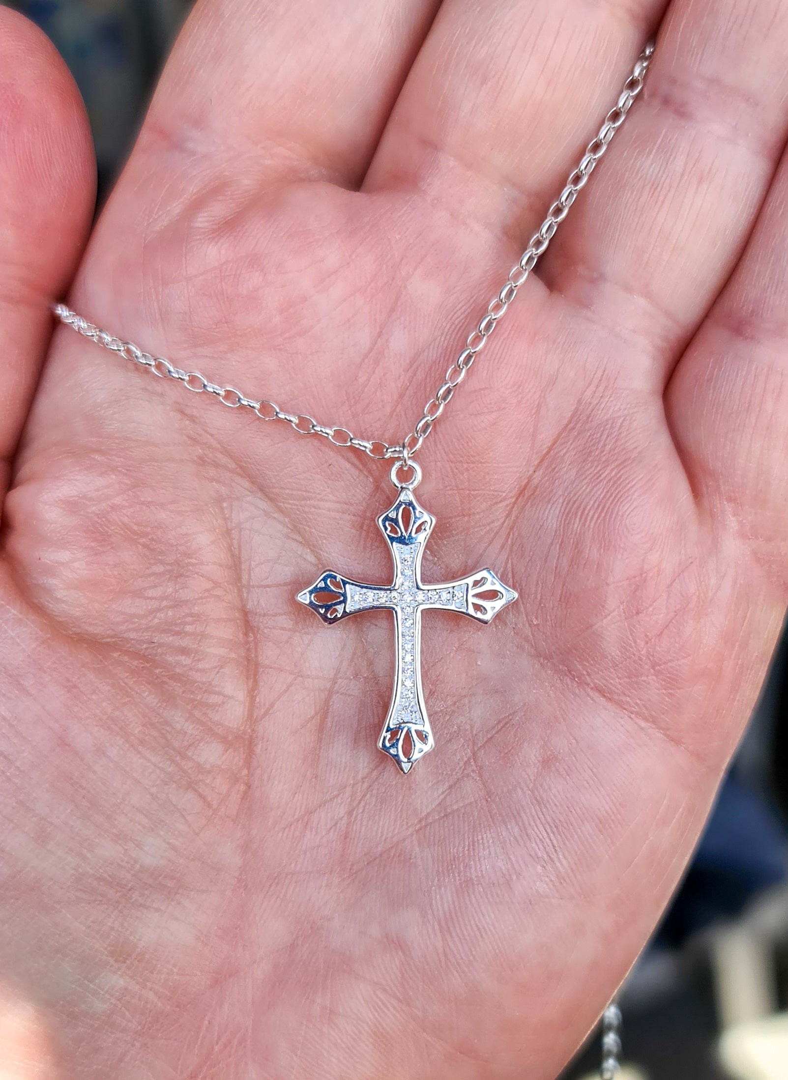 A sterling silver 925 necklace with a large silver cross pendant with small encrusted crystals for Irish communion or confirmation gifts for girls in Ireland.