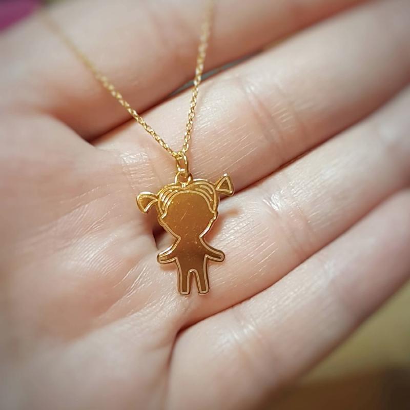 24k gold plated sterling silver necklace with a pendant of a little girl silhouette, showcased on a human hand to emphasize size and elegance, a Personalised Silver Jewellery Ireland by Magpie Gems