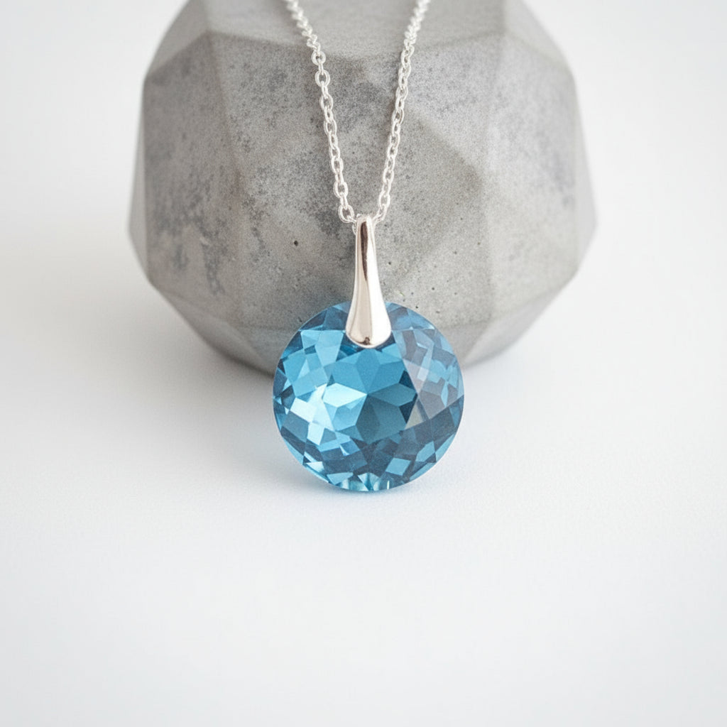 Sterling silver March birthstone pendant necklace featuring faceted Aquamarine blue Austrian crystal, handcrafted in Ireland by Magpie Gems.