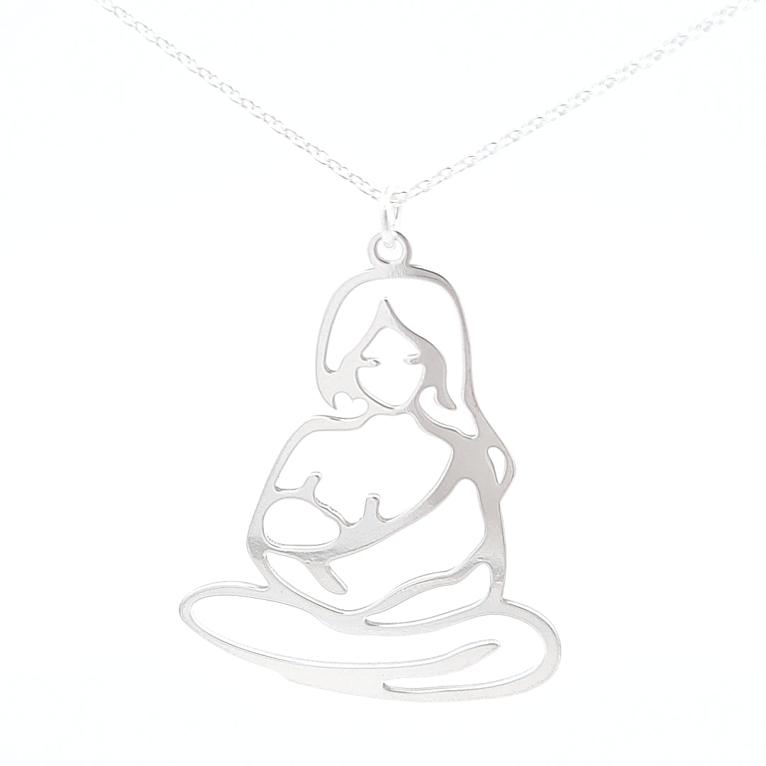 A close-up of the Maternal Glow Breastfeeding Pendant on a 45cm chain, featuring a silver figure of a mother holding and breastfeeding her baby.