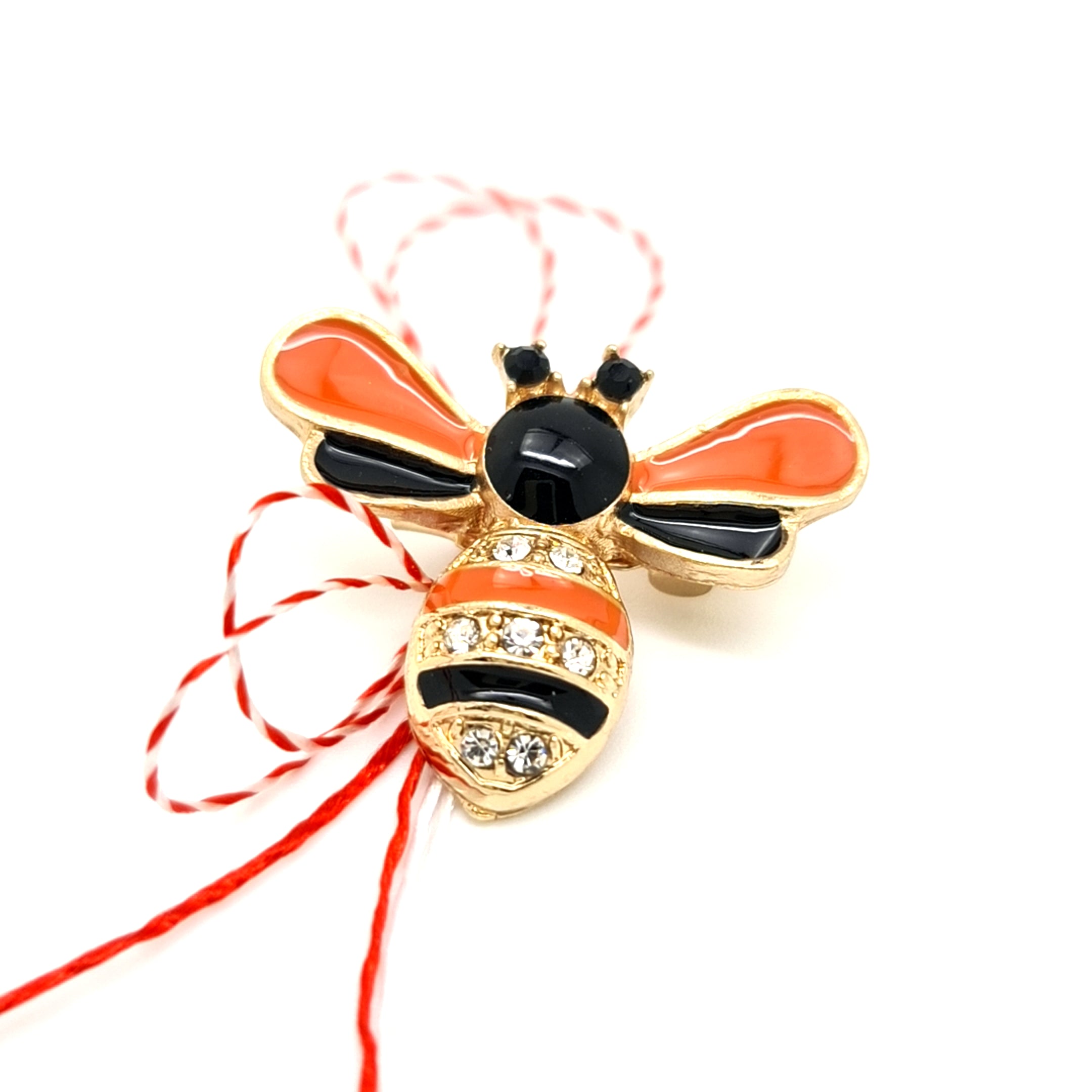 Enamel Bumblebee Martisor Brooch in Orange with Gold Plating and Crystal Details, Tied with Red and White Martisor String.