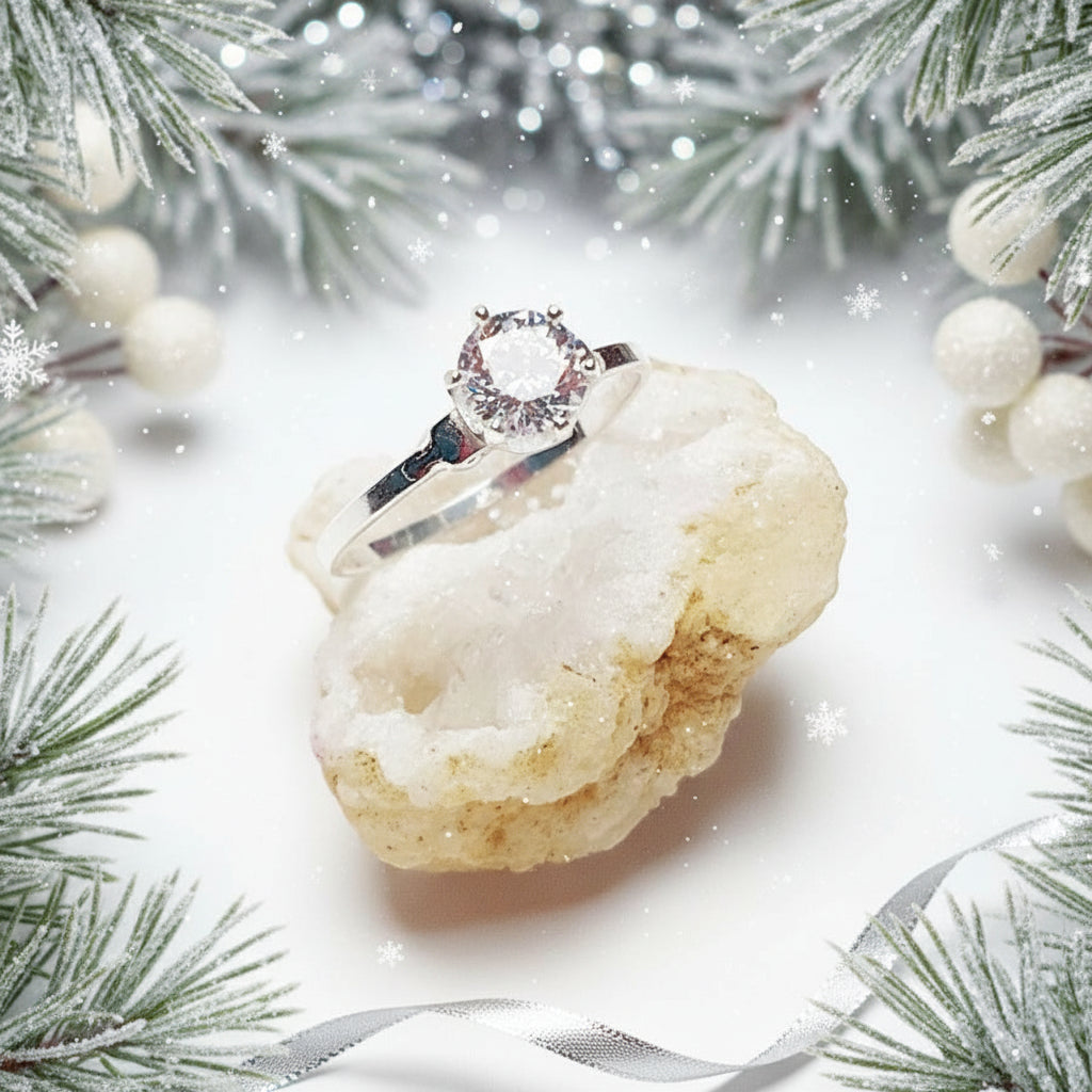 Festive Christmas-themed image of a sterling silver solitaire ring with cubic zirconia displayed on a crystal rock, perfect gift from Magpie Gems Ireland.