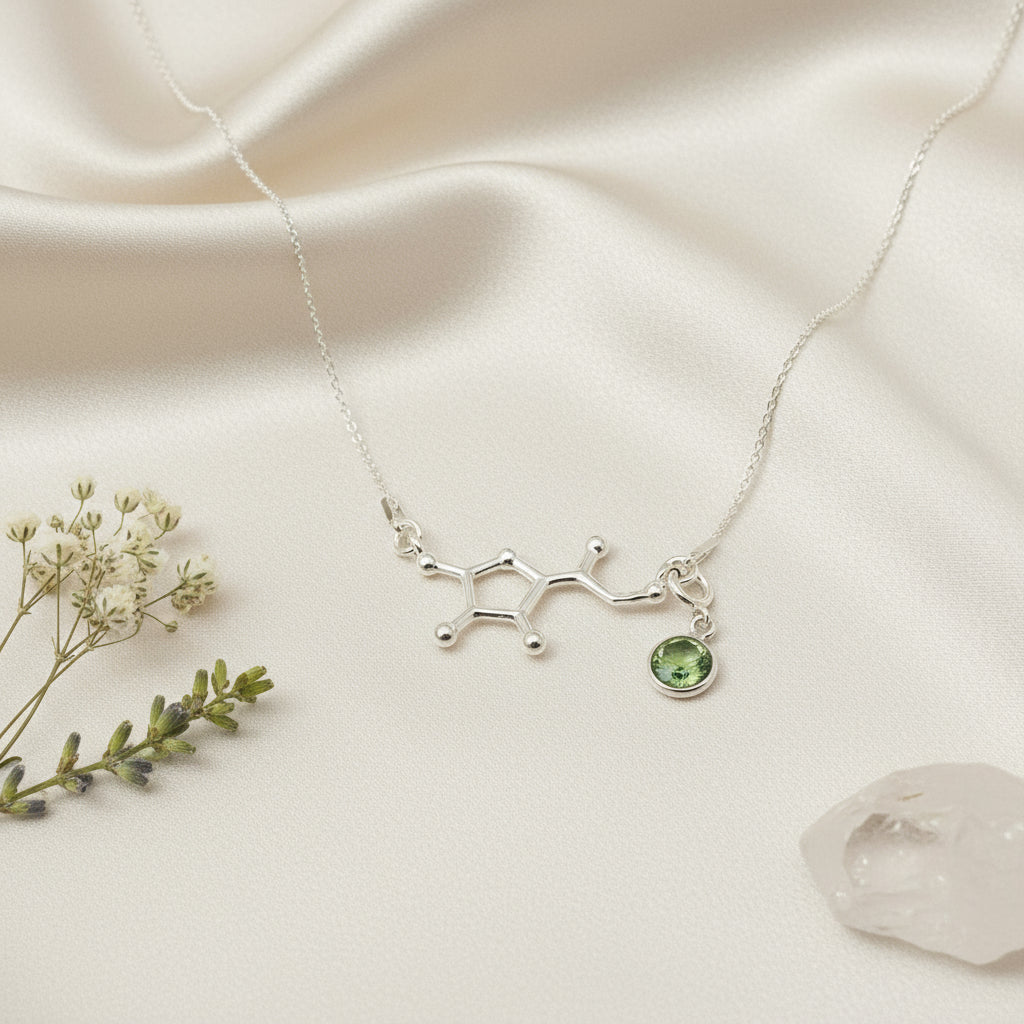 Sterling silver Vitamin C molecule necklace paired with a removable August Peridot birthstone charm, handmade by Magpie Gems.