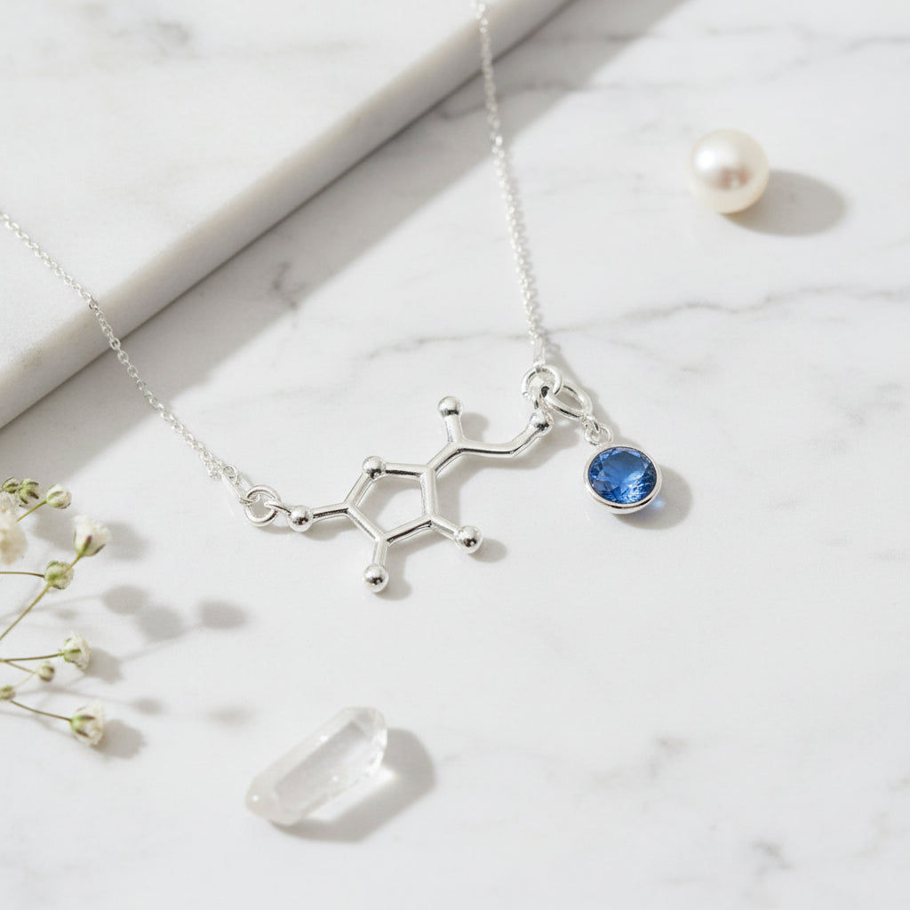 Silver Vitamin C molecule necklace with a detachable September Sapphire birthstone charm, meaningful science jewellery by Magpie Gems.